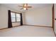 Bedroom featuring a ceiling fan, neutral carpet, and windows with curtains at 2265 Pine Point Dr, Lawrenceville, GA 30043