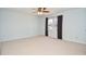 Empty bedroom featuring a ceiling fan, neutral carpet, and a window with curtains at 2265 Pine Point Dr, Lawrenceville, GA 30043