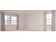 Spacious bedroom with ample natural light from two large windows at 2265 Pine Point Dr, Lawrenceville, GA 30043