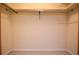 Empty walk-in closet with neutral walls and carpeting, ready for organization at 2265 Pine Point Dr, Lawrenceville, GA 30043