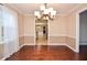 Formal dining room featuring hardwood floors, neutral wall colors, and a decorative chandelier at 2265 Pine Point Dr, Lawrenceville, GA 30043