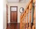 Elegant foyer with hardwood floors, decorative mirror, and wooden banister at 2265 Pine Point Dr, Lawrenceville, GA 30043