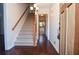 Inviting foyer with hardwood floors, staircase, and a view into the adjacent kitchen at 2265 Pine Point Dr, Lawrenceville, GA 30043