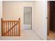 Hallway with wood railing, neutral carpeting, and view into adjoining room at 2265 Pine Point Dr, Lawrenceville, GA 30043