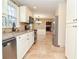 Well-lit kitchen with stainless steel appliances, granite countertops, and a view to the living room at 2265 Pine Point Dr, Lawrenceville, GA 30043