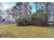 Spacious backyard partially fenced-in with mature trees providing shade and privacy at 2600 Burkshire Rd, Ellenwood, GA 30294