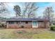 Exterior back view of a brick house, offering a large yard and a sliding door to the patio at 2600 Burkshire Rd, Ellenwood, GA 30294