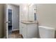 Bright bathroom featuring an updated granite-topped vanity and a comfort-height toilet at 2600 Burkshire Rd, Ellenwood, GA 30294