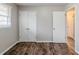 Bedroom featuring wood floors, a window, and a closet at 2600 Burkshire Rd, Ellenwood, GA 30294