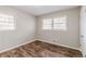 Bedroom featuring two windows, wood floors, and light colored walls at 2600 Burkshire Rd, Ellenwood, GA 30294