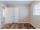 Bedroom featuring wood floors, a window, and a closet at 2600 Burkshire Rd, Ellenwood, GA 30294