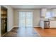 Dining area with modern wood flooring, neutral walls, and sliding glass door and view of backyard at 2600 Burkshire Rd, Ellenwood, GA 30294