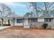 Charming single-story home featuring a brick facade, covered porch, and attached carport at 2600 Burkshire Rd, Ellenwood, GA 30294