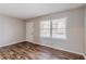 Bright living room with wood floors, neutral walls, and a large window with natural light at 2600 Burkshire Rd, Ellenwood, GA 30294