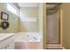 Nicely designed bathroom with a soaking tub and a glass-enclosed shower at 4035 Crabapple Lake Ct, Roswell, GA 30076