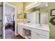 Bathroom boasts dual sinks and a view of the adjacent bedroom at 4035 Crabapple Lake Ct, Roswell, GA 30076