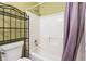 Bathtub/shower combo features a shower curtain and shelving unit at 4035 Crabapple Lake Ct, Roswell, GA 30076