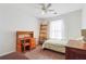 Cozy bedroom with a ceiling fan, a wooden desk, and a charming decorative ladder at 4035 Crabapple Lake Ct, Roswell, GA 30076