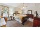 Comfortable bedroom featuring a ceiling fan, carpet, and a floral-curtained window at 4035 Crabapple Lake Ct, Roswell, GA 30076