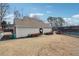 Exterior view of the community building with trimmed garden and a view of the tennis court at 4035 Crabapple Lake Ct, Roswell, GA 30076