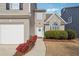 Inviting front entrance featuring a well-manicured garden, brick facade, and a stylish front door at 4035 Crabapple Lake Ct, Roswell, GA 30076