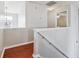 Hallway with hardwood floors featuring staircase and natural lighting at 4035 Crabapple Lake Ct, Roswell, GA 30076