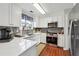 Modern kitchen showcasing white cabinets, stainless steel appliances, and a gray subway tile backsplash at 4035 Crabapple Lake Ct, Roswell, GA 30076