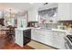 Open kitchen with white cabinetry, stainless appliances, and a view to the living area at 4035 Crabapple Lake Ct, Roswell, GA 30076