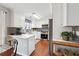 Bright kitchen featuring white cabinets, stainless steel appliances, and a subway tile backsplash at 4035 Crabapple Lake Ct, Roswell, GA 30076