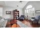 Comfortable living room with a large window, ample seating, and bookshelves at 4035 Crabapple Lake Ct, Roswell, GA 30076