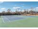 Well-maintained tennis courts with community playground and neighborhood homes in the background at 4035 Crabapple Lake Ct, Roswell, GA 30076