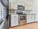 Kitchen with white cabinets, granite counters and stainless steel appliances at 6790 Fairways Dr, Douglasville, GA 30134