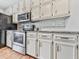 Kitchen with white cabinets, granite counters, and stainless steel appliances at 6790 Fairways Dr, Douglasville, GA 30134