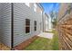 Private backyard with a concrete patio and gray siding at 702 Smokey Quartz Way, Kennesaw, GA 30144