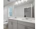 Modern bathroom with double vanity, large mirror, and a bathtub at 702 Smokey Quartz Way, Kennesaw, GA 30144