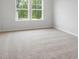 Bright bedroom with carpet and large windows at 702 Smokey Quartz Way, Kennesaw, GA 30144