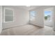 Bright bedroom with neutral walls, carpet flooring, and two windows at 702 Smokey Quartz Way, Kennesaw, GA 30144