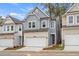 Two-story townhome with gray siding, white trim, and a two-car garage at 702 Smokey Quartz Way, Kennesaw, GA 30144