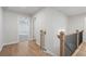 Upstairs hallway with wood floors and access to bedrooms at 702 Smokey Quartz Way, Kennesaw, GA 30144