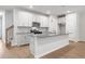 Modern kitchen with white shaker cabinets, gray countertops, and stainless steel appliances at 702 Smokey Quartz Way, Kennesaw, GA 30144