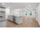 Open concept kitchen with gray countertops, white cabinets, and a large island at 702 Smokey Quartz Way, Kennesaw, GA 30144