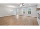 Spacious living room featuring hardwood floors, fireplace and ceiling fan at 702 Smokey Quartz Way, Kennesaw, GA 30144