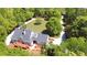 Spacious home with a private drive, complemented by lush greenery and well-manicured lawns at 866 Lee Byrd Rd, Loganville, GA 30052