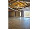 View of unfinished basement leading to garage, with exposed ceiling and framed walls at 866 Lee Byrd Rd, Loganville, GA 30052