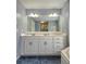 Bathroom featuring double sink vanity, large mirror, and modern hardware at 866 Lee Byrd Rd, Loganville, GA 30052