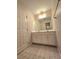 Well-lit bathroom featuring a double sink vanity and tile flooring at 866 Lee Byrd Rd, Loganville, GA 30052