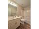 Bathroom with wood-look flooring, vanity, and shower-tub combo at 866 Lee Byrd Rd, Loganville, GA 30052