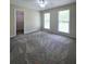 Spacious bedroom with plush carpet and natural light from multiple windows at 866 Lee Byrd Rd, Loganville, GA 30052