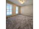 Spacious bedroom with two bright windows and plush carpeting at 866 Lee Byrd Rd, Loganville, GA 30052