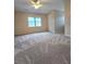 Bedroom features a ceiling fan, window, and neutral-toned walls at 866 Lee Byrd Rd, Loganville, GA 30052